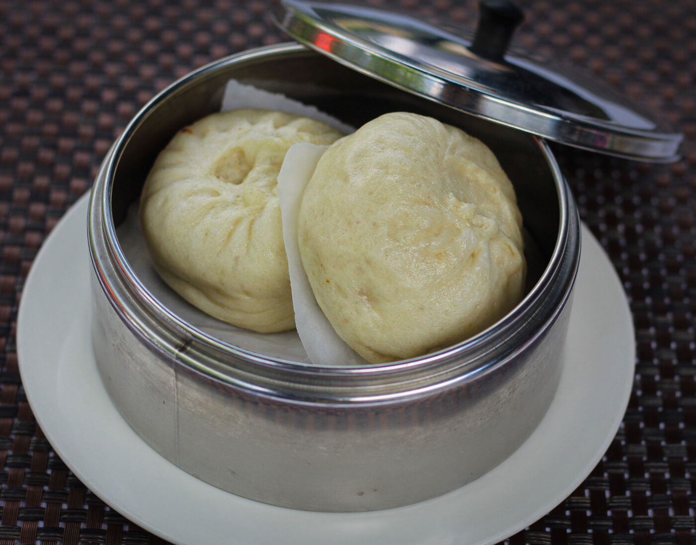Steamed pork buns in a bamboo steamer