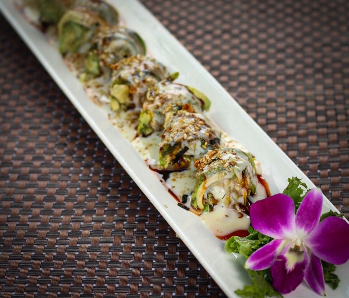 A long platter of specialty sushi rolls